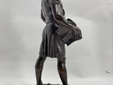 statue of a woman holding a basket on a marble base