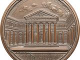 an image of a bronze medal with a building in the background