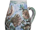 a blue and white vase with a floral design on it