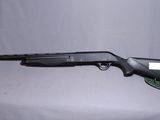 a shotgun that is sitting on top of a table