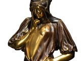 bronze statue of a woman with her hands on her face
