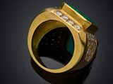 a close up of a gold ring with a green stone and diamonds