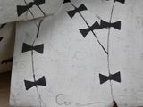 a close up of a bed with a black and white pattern on it
