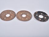 two pieces of metal with holes and holes in them on a white surface