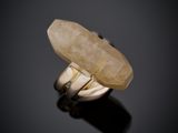 an image of a ring with a stone in it on a black surface