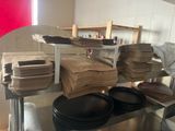 many plates and pans sitting on a shelf in a kitchen