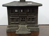 a small toy house sitting on a wooden table