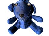 a blue stuffed animal that is sitting on a white surface