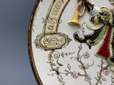 a decorative plate with a figurine of a man playing a trumpet