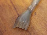 a plastic brush sitting on top of a wooden table