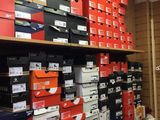 boxes of various sizes and colors are stacked on a shelf in a store