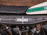 a close up of a motorcycle with a green and white emblem