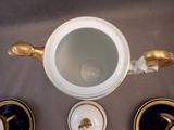 an overhead view of a coffee pot and two cups