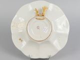 underside view of a saucer with a gold decoration