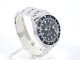 rolex watch with black dial and white bracelet on a white background
