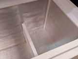a metal sink in the middle of a wooden table