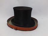 a black top hat sitting on top of a brown belt