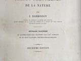an old book with black writing on it sitting on top of a table
