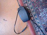 an image of a mouse and a cord on a rug