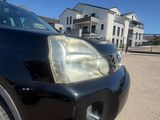 a black suv parked in a parking lot near a building
