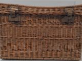an old wicker trunk with two handles and a handle