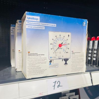 a box with a clock on the shelf in a store