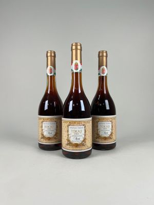 three bottles of wine sitting next to each other on a table