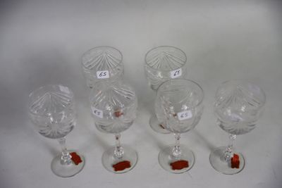 six wine glasses with labels on them sitting on a white surface