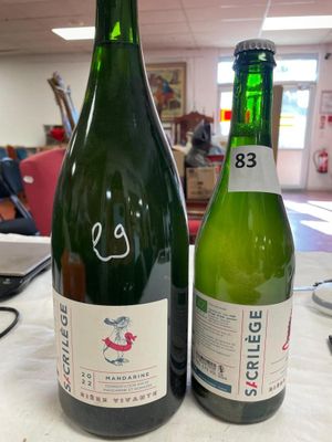 two bottles of wine that are sitting on a table