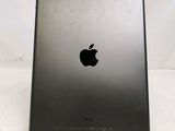 an apple ipad is sitting on a stand on a white surface