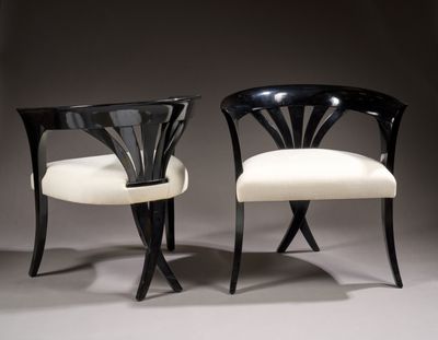 pair of black and white chairs with white upholstered seats