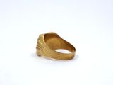 a close up of a gold ring on a white surface