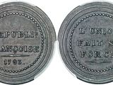 a close up of a coin on a white surface