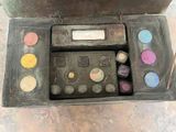 a box with a lot of different colored eyeshadows in it
