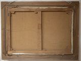 an old picture frame hanging on a wall in a room