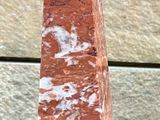 two red marble obelisks on a black table