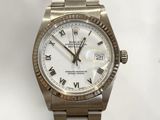 a close up of a wrist watch with roman numerals on it
