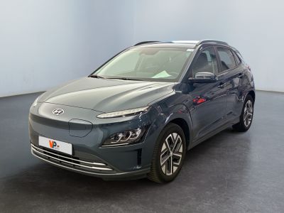 the grey car is parked in a large room with a black floor