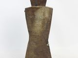 a brown vase that is sitting on a white surface