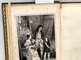 un vieux livre avec l'image d'une femme et de deux enfants