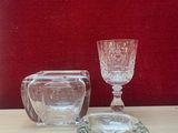 a small glass cup and a small glass bowl on a table