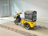 a yellow motorcycle with a cart on the back of it