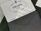 a black purse with a card attached to it and a wallet with a credit card attached to it