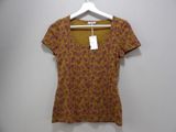 an image of a women ' s shirt hanging on a hanger