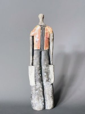 statue of a man in a gray suit with a red tie