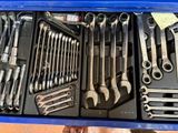 many wrenches in a blue box on a table