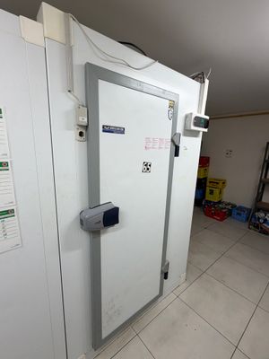 a white door in the middle of a room with a white tile floor