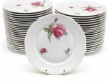 several plates with pink roses are stacked on top of each other