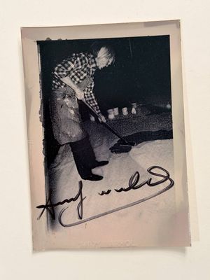 an old photo of a man playing a guitar in a room