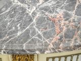 marble top of a table with a gold and white design on top of it